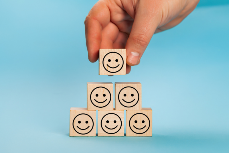 Stock image of 6 smiley faces being stacked up