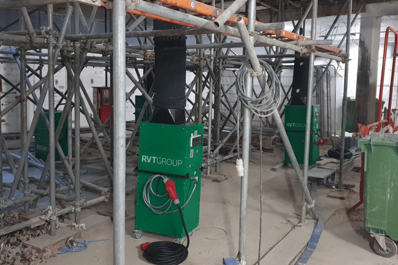 Two Climex Electric Fan Heater 18FD in use in the middle of scaffolding during live construction with diffusers erected