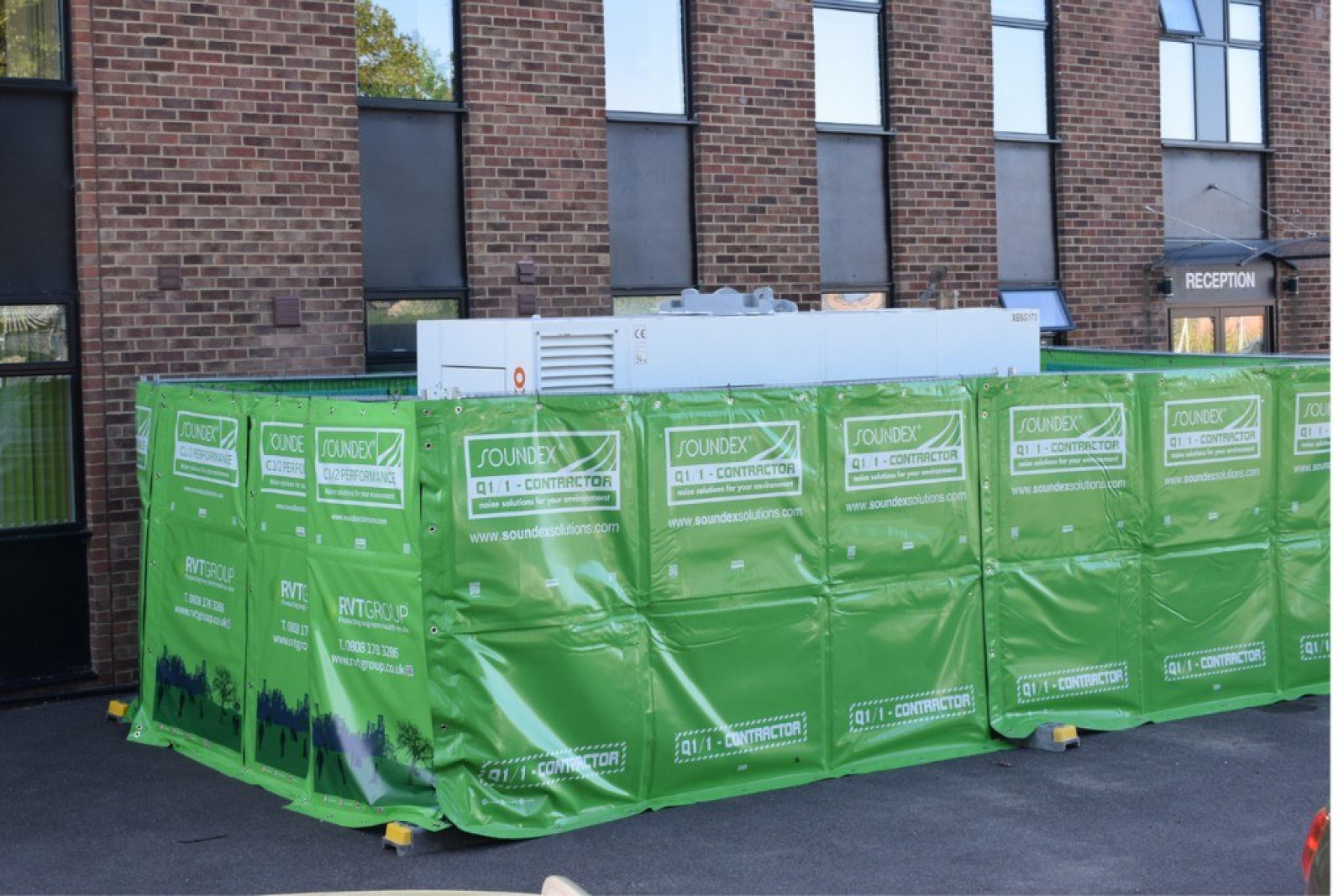 Soundex Acoustic Quilt surrounding a generator near an office