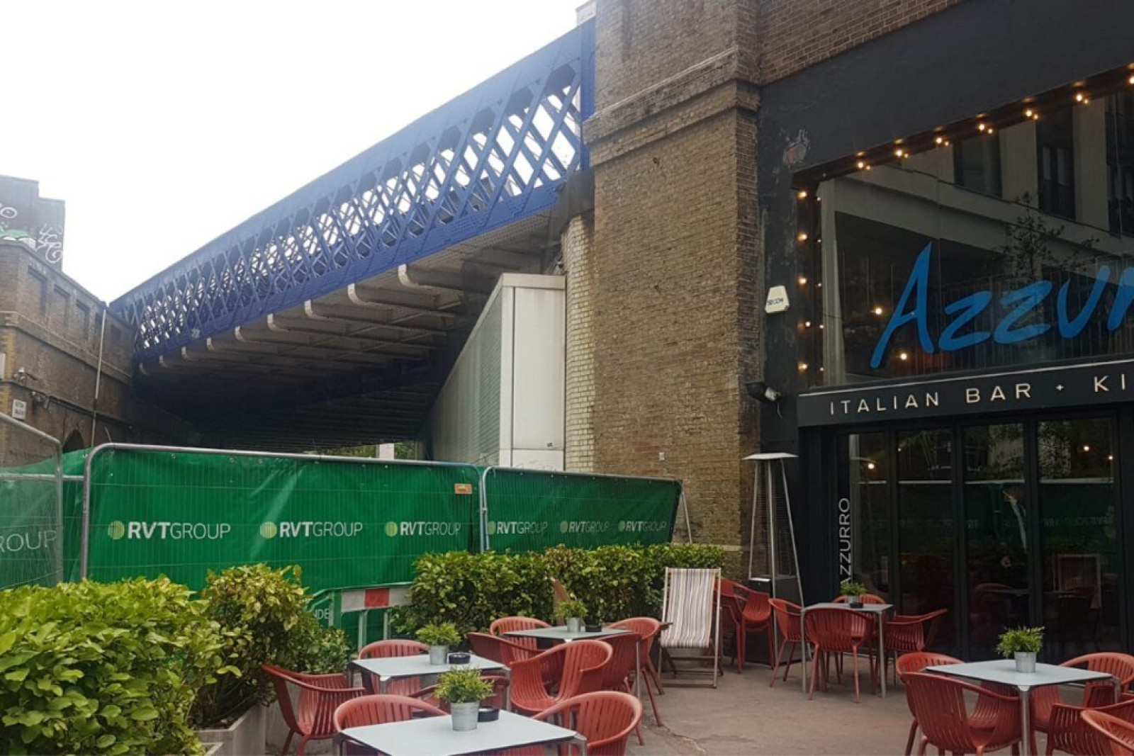 Soundex Acoustic Quilts attached to a fence between works taking place and a live restaurant