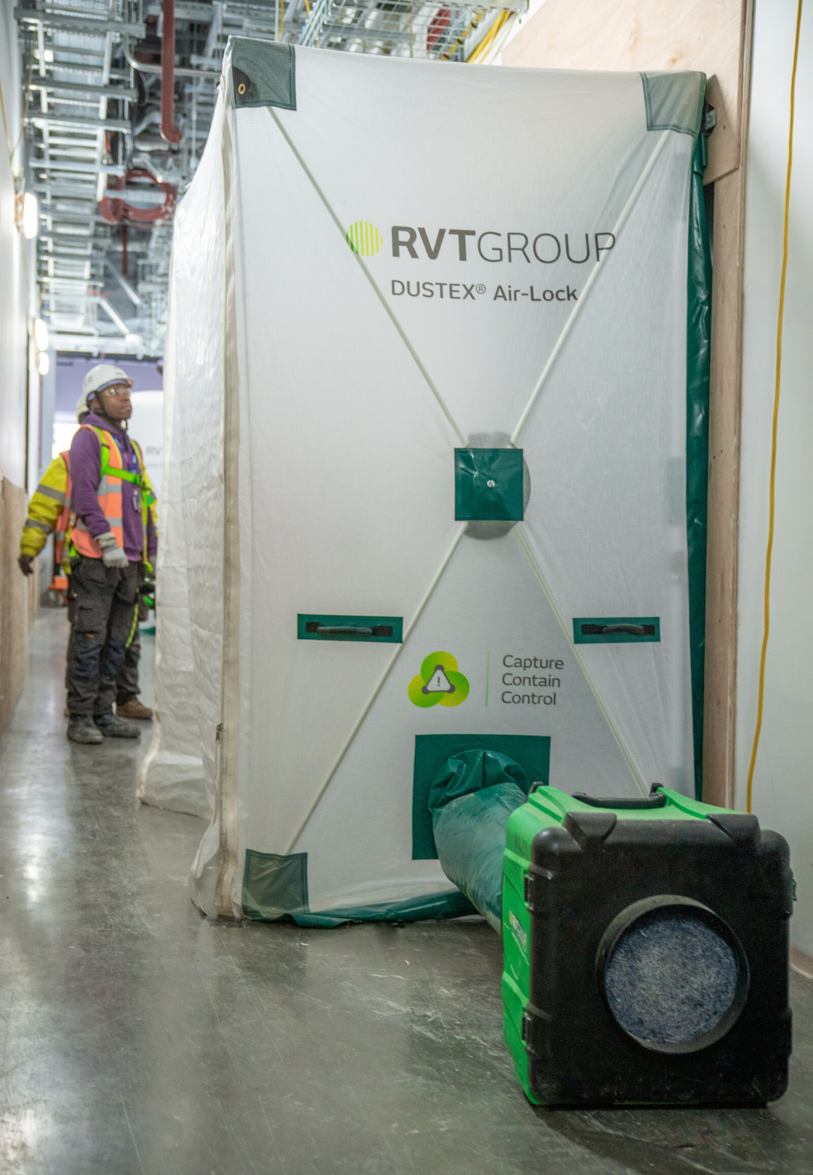 Dustex Airlock and raptor dust extraction on a live site with workers in the background