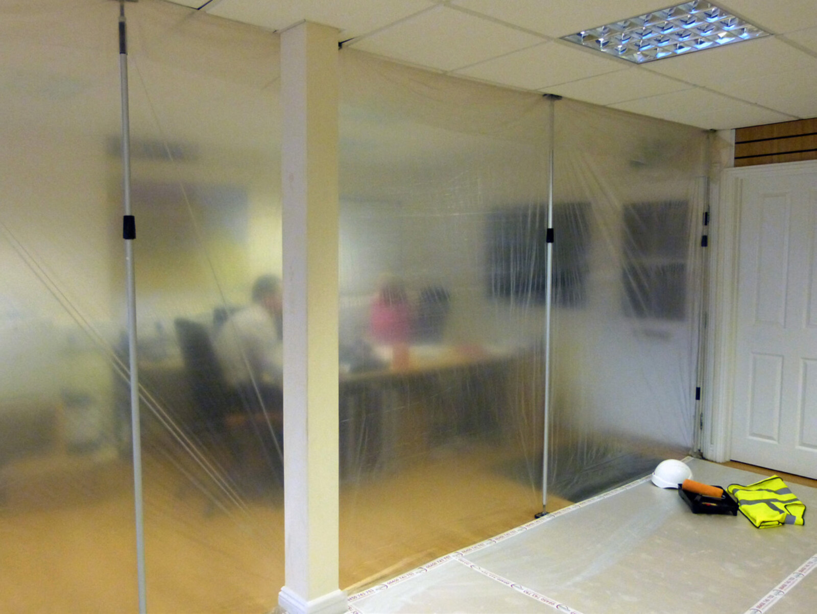 Dustex Quick props used to create a dust sheet barrier between a live office environment and adjacent work area