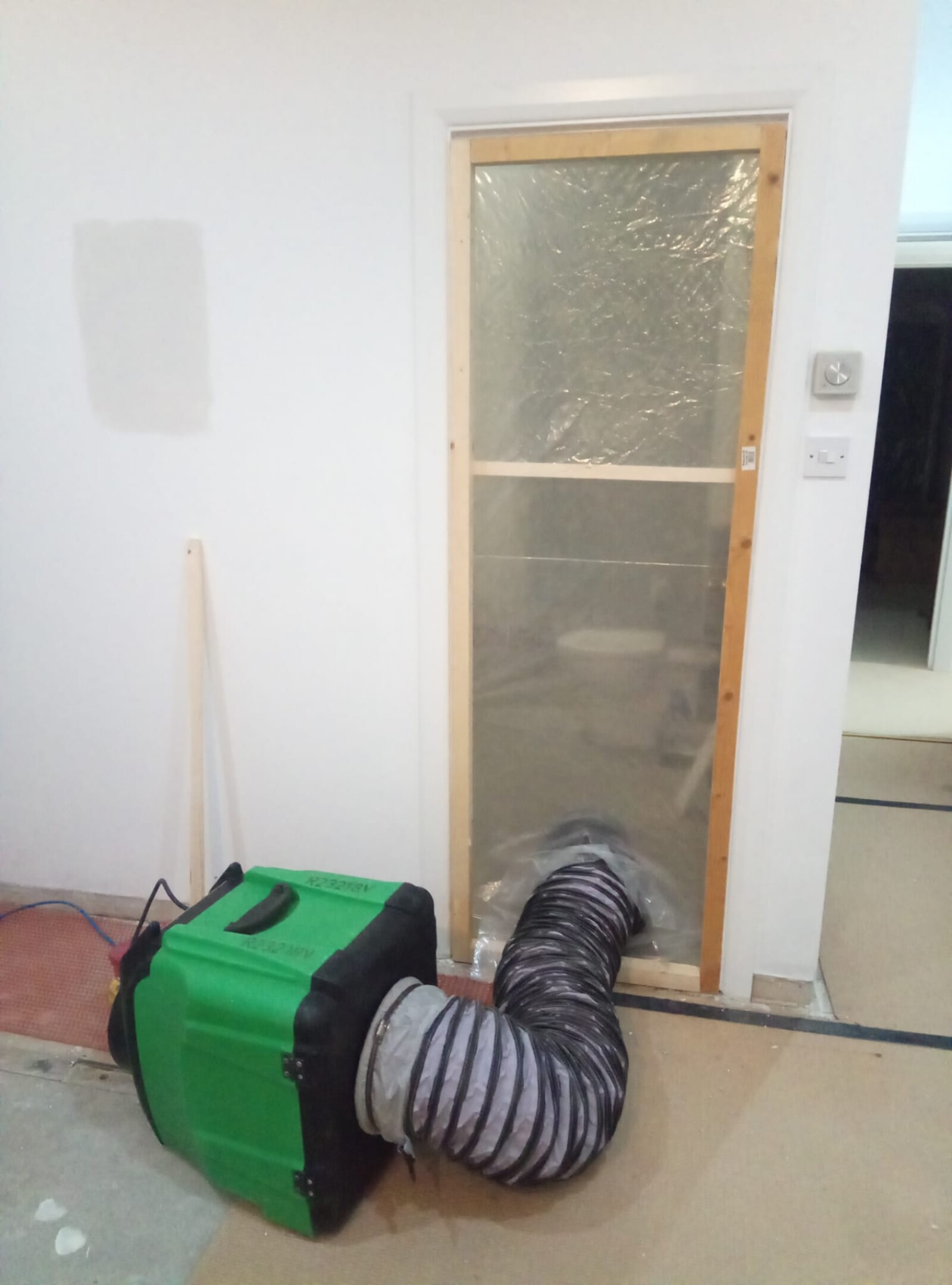 Dustex Raptor in use with dust sheets, ready for negative pressure dust extraction