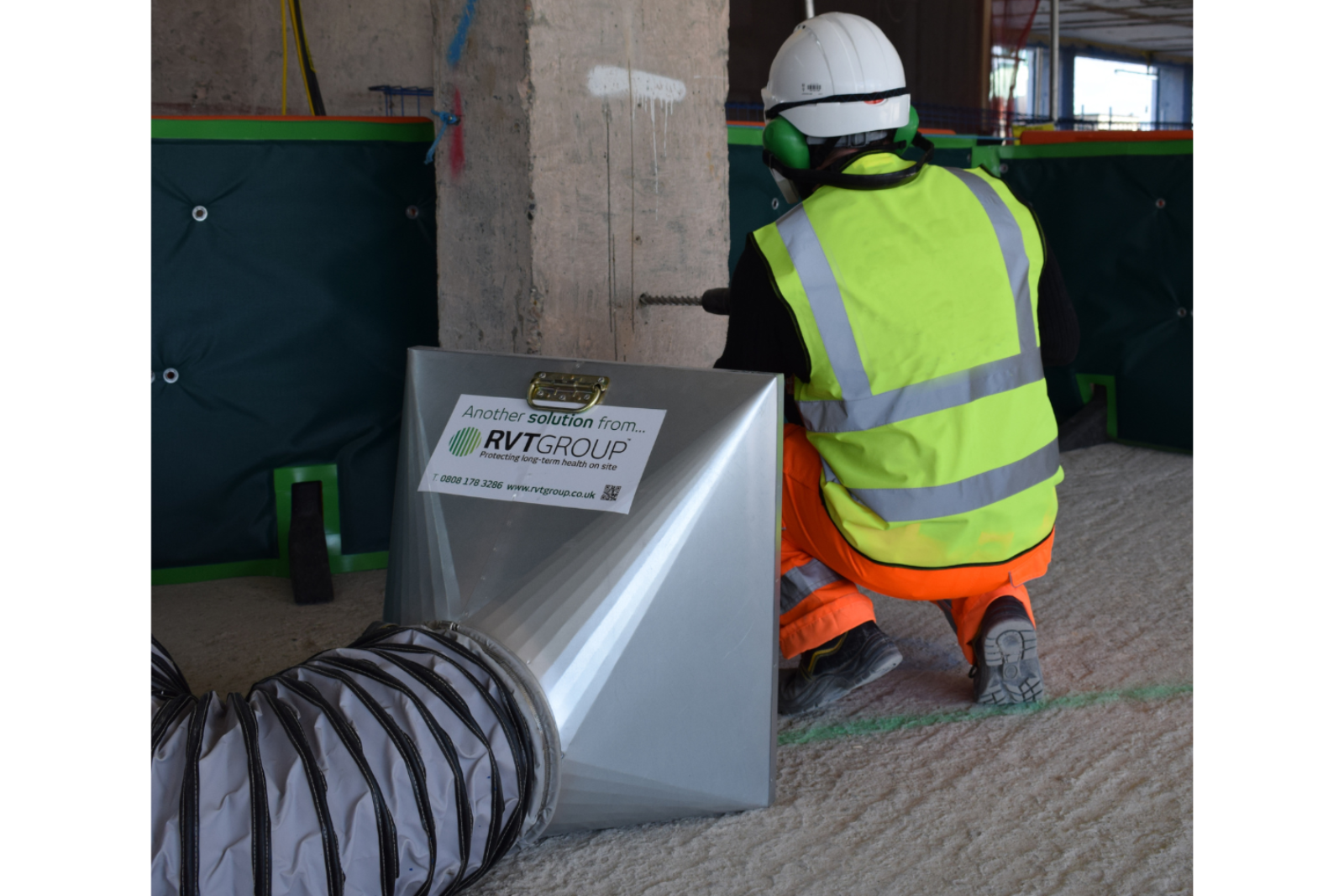 A metal capture hood capturing dust at the source whilst a worker does cutting works