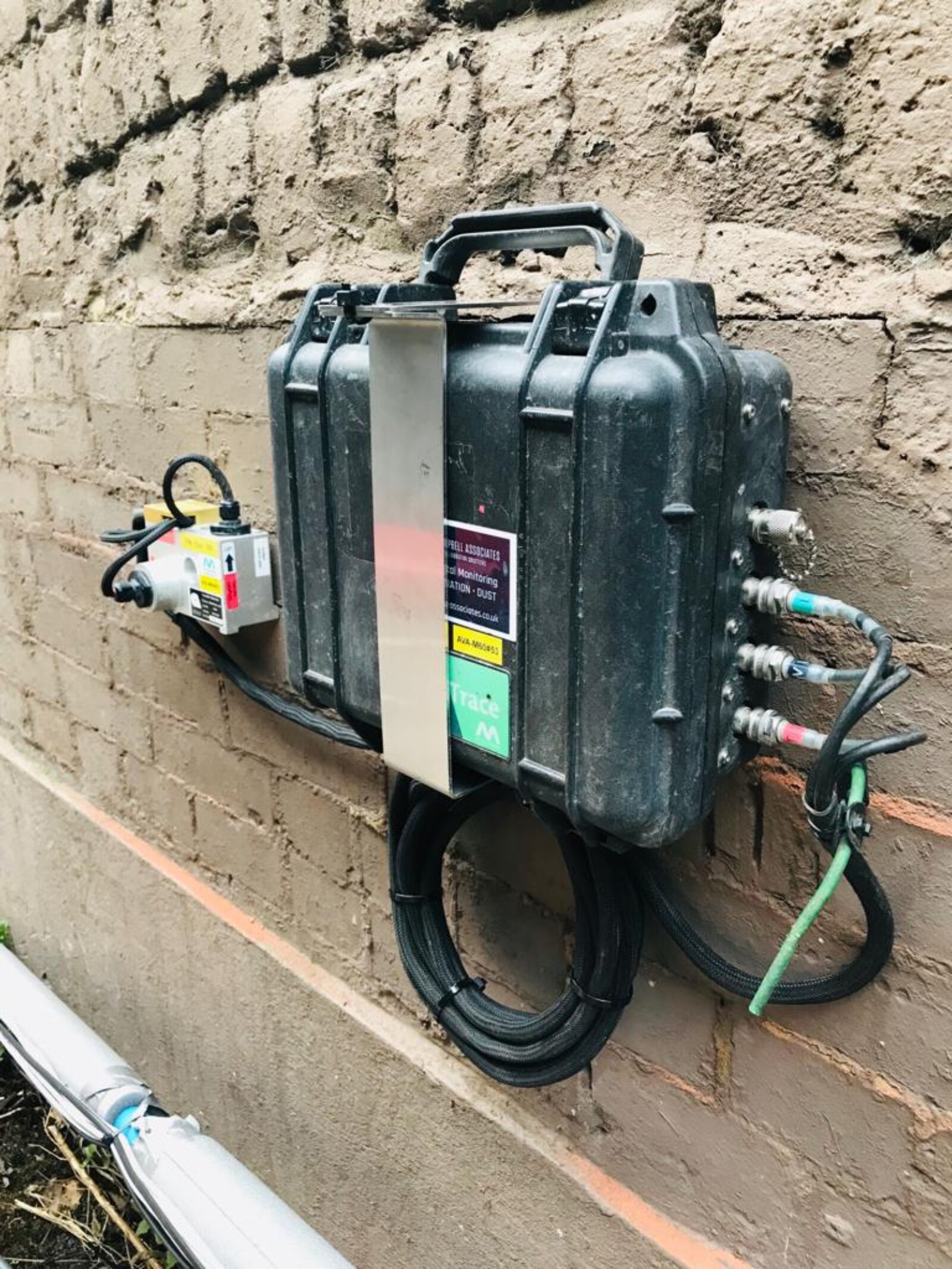 Close up of a Monitex vibration monitor mounted on an external wall