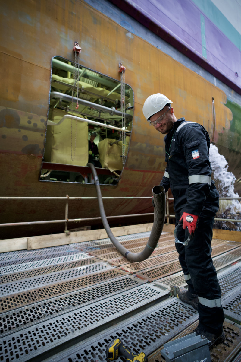 RVT Group engineer feeding ducting through ship
