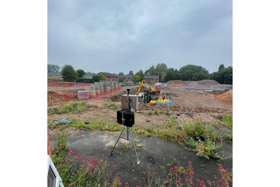 Dust monitor in foreground and live construction in background