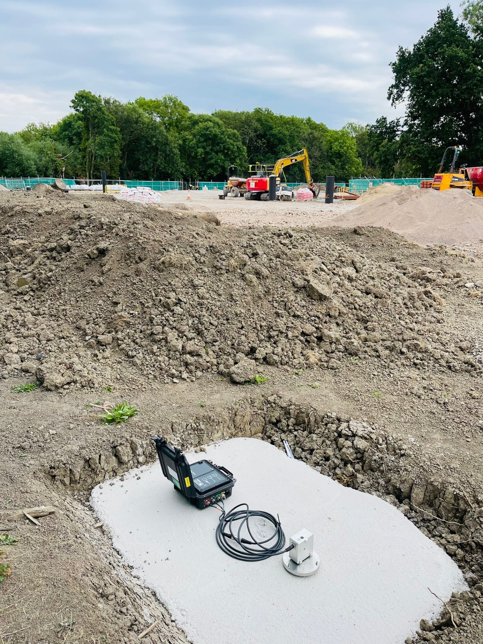 MONITEX OD-AA Vibration Monitor on a cement slab whilst excavation works take place in the background