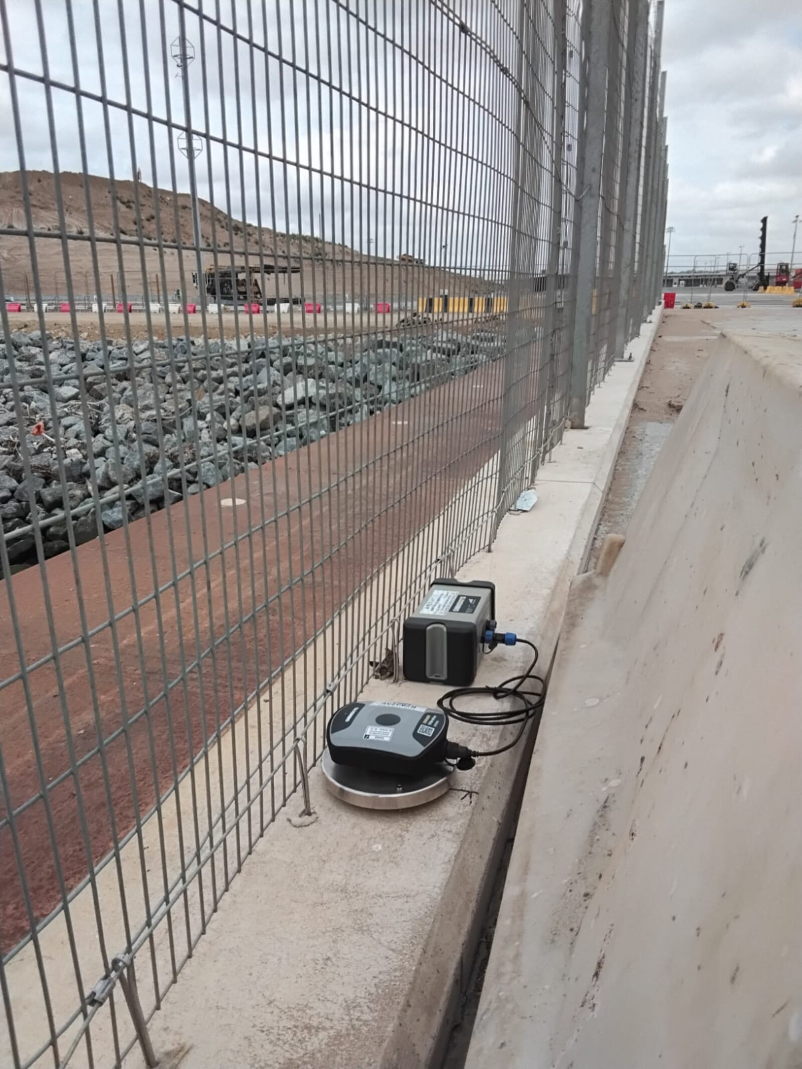MONITEX OD-AA Vibration Monitor on a major infrastructure project with piling taking place in the background