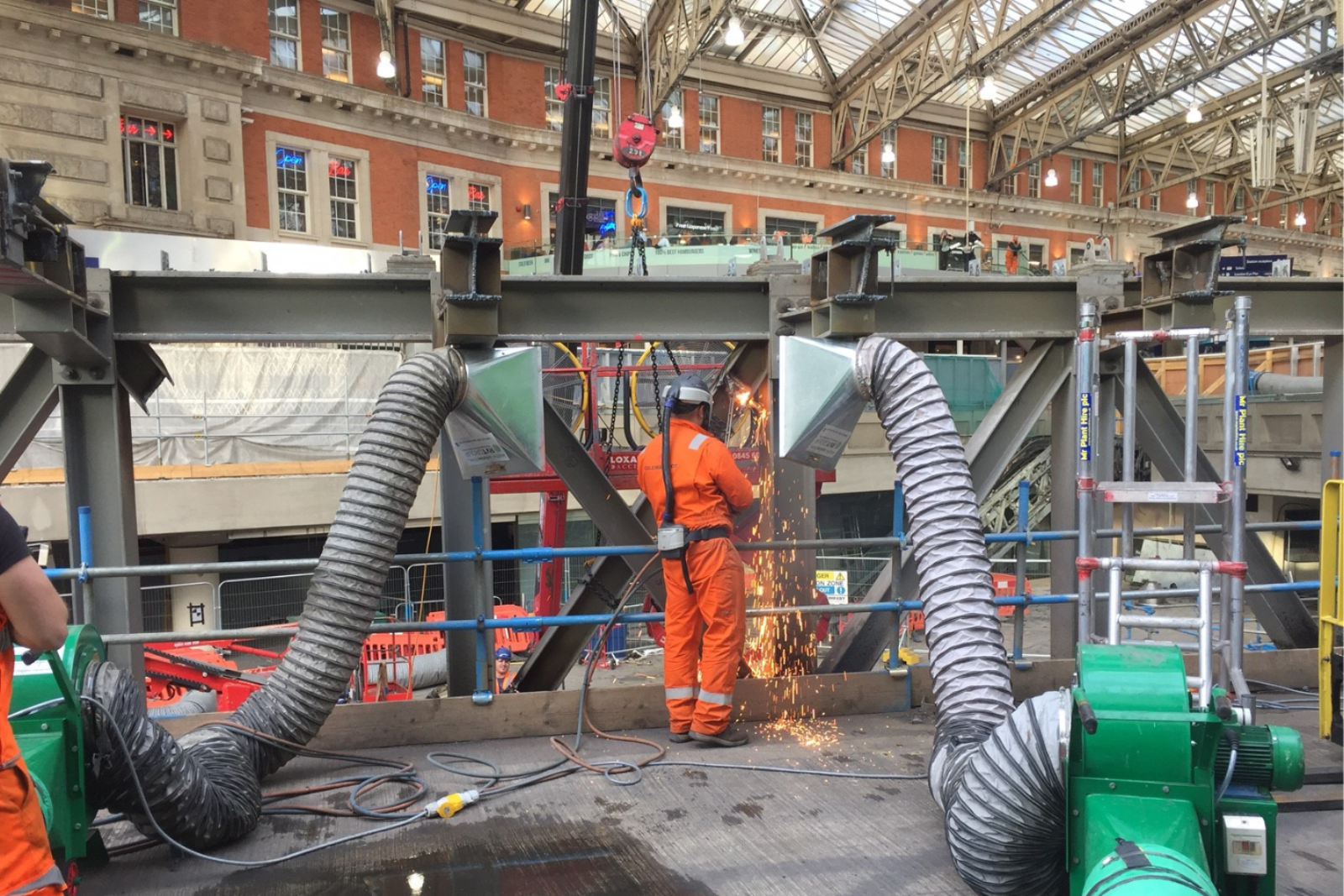 Metal capture hood being used for fume extraction at a live train station project