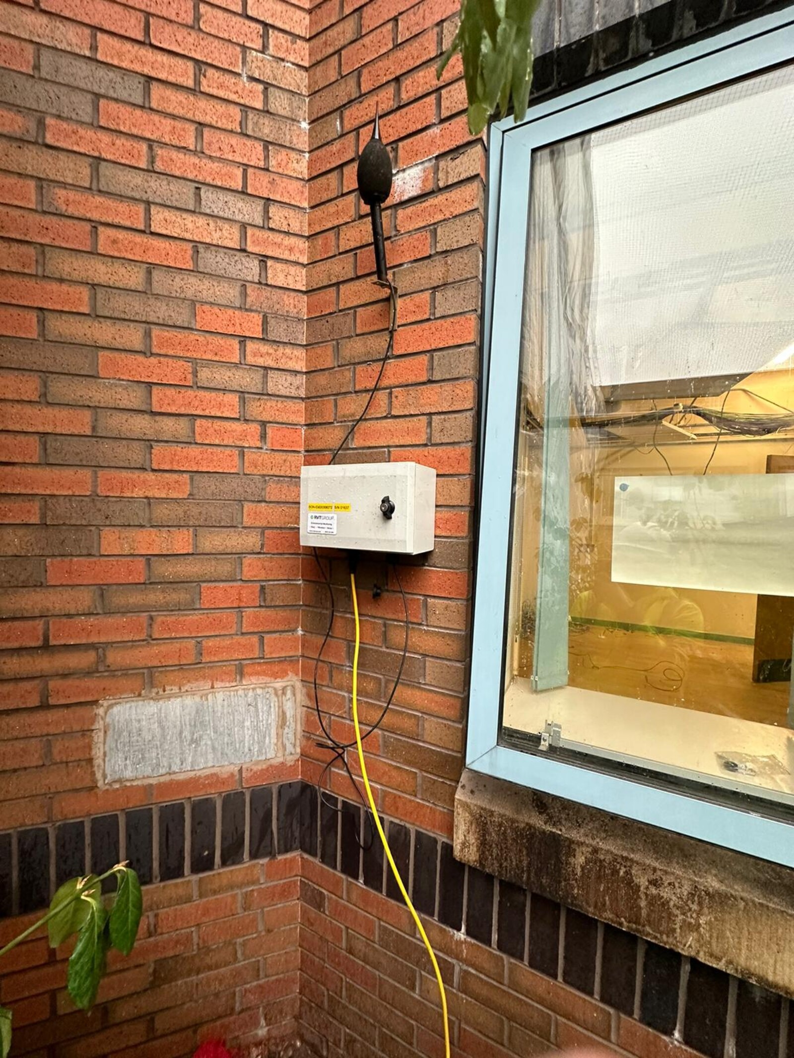 Monitex Area noise monitor mounted to the side of a building