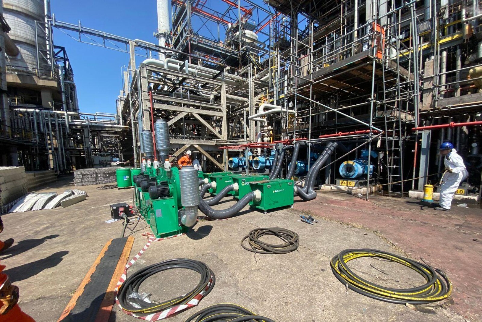 Several VENTEX Centrifugal Fan 200S-HPs making up part of a number of fume extraction systems on the floor with pipework entering an oil refinery