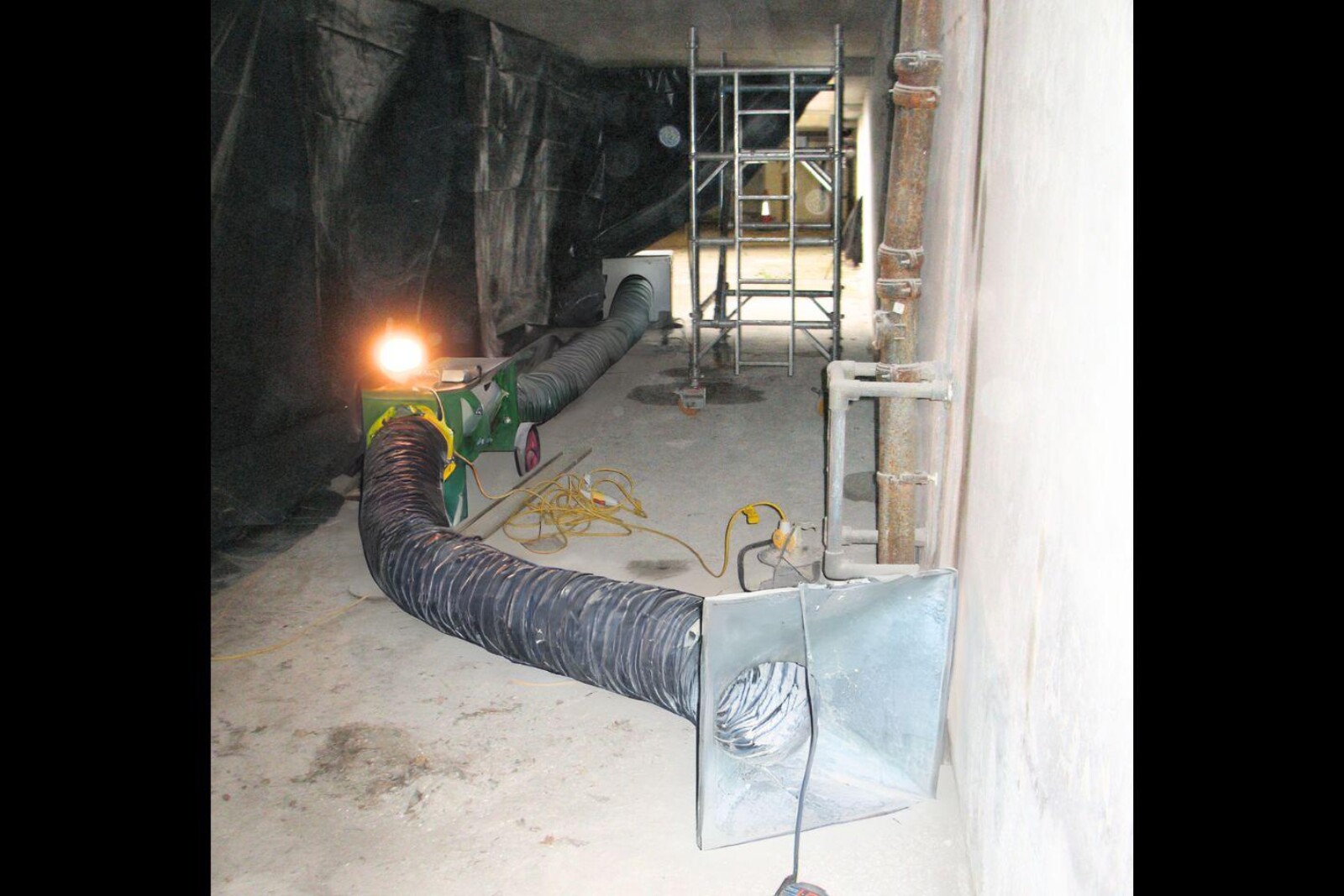 VENTEX Twin Axial Fan 300M and dust extraction unit behind a sheet on a live basement project