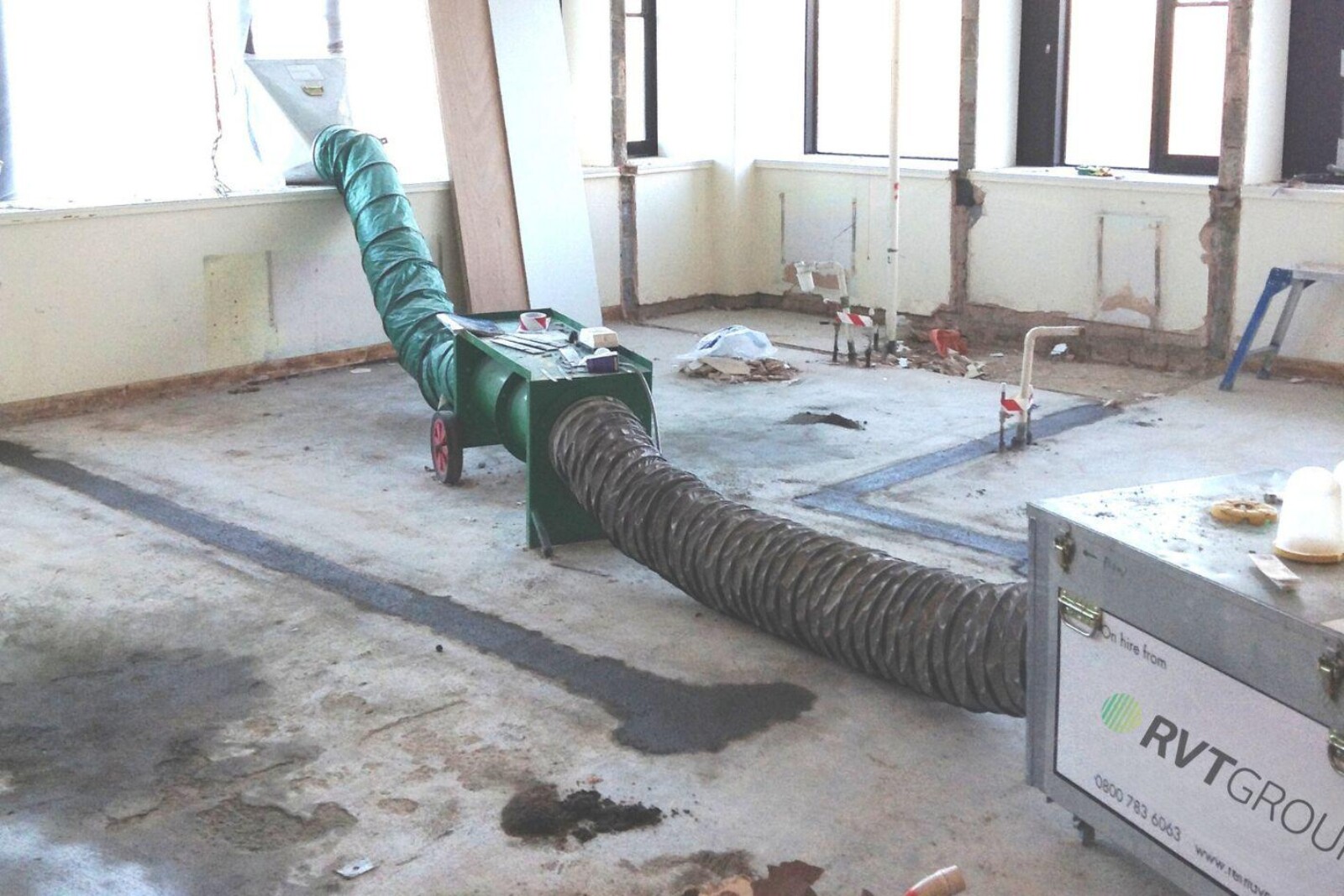 VENTEX Twin Axial Fan 300M and dust extraction unit in use during internal wall chasing works