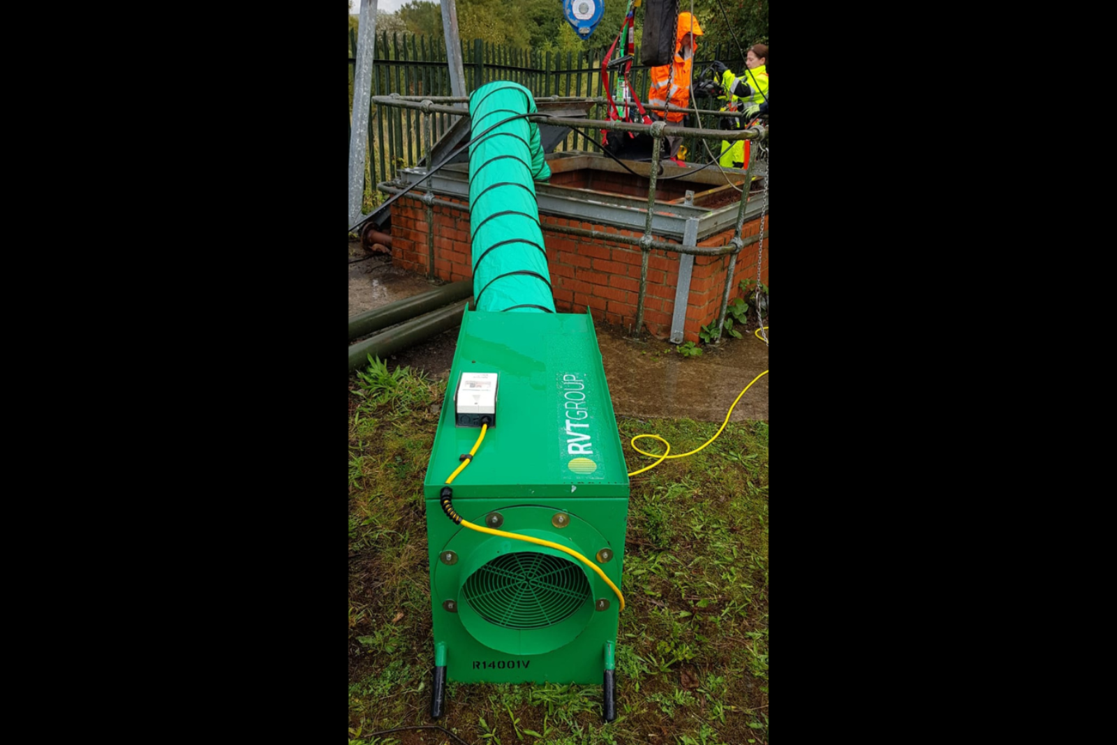 VENTEX Twin Axial Fan 300M with ducting entering a confined space with workmen nearby