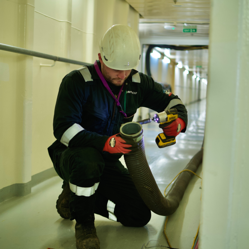 Engineer installing ducting