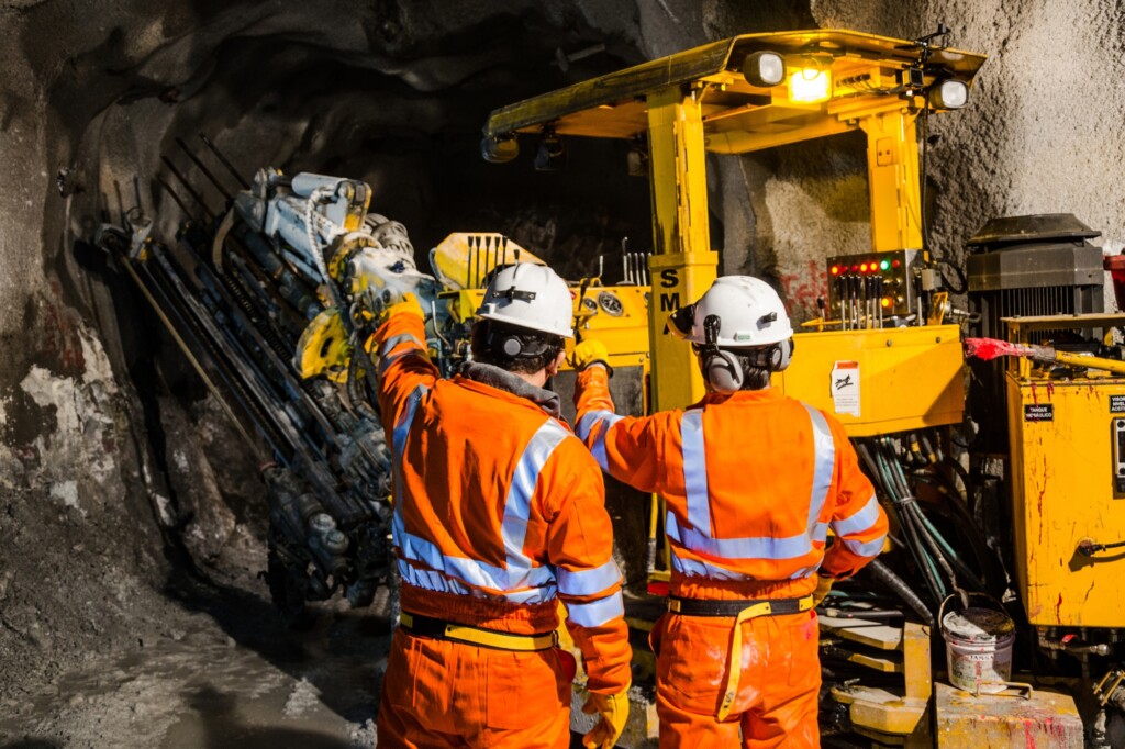 workers in high-vis PPE overalls during underground excavation